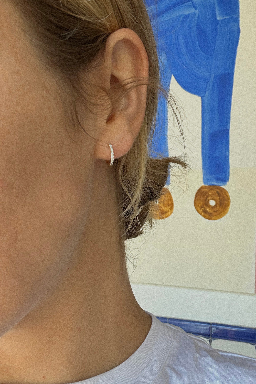 The "Mini Bling Diamond Hoop" 18K Solid Gold earrings with diamonds